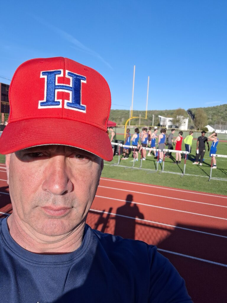 Coach Joe in the foreground with the hartford team in the background
