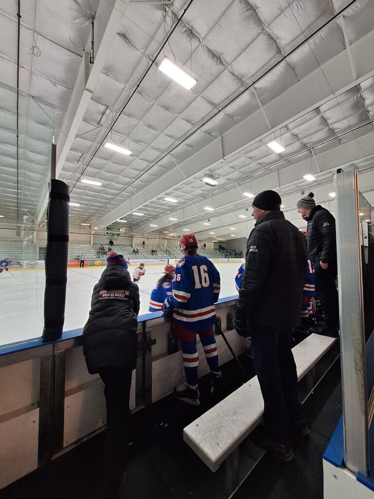 Joe overseeing athletes on the hockey rink